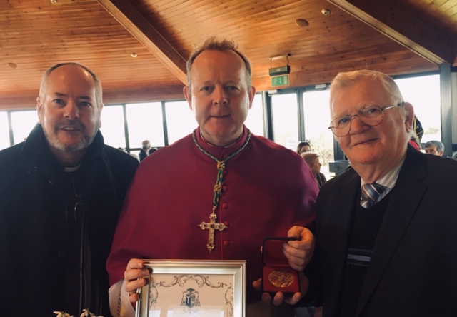 Provincial of the Irish-American Province, Fr. Joseph O'Reilly (left) is pictured with Mr. Peter Mallon (right), as he is awarded the Medal of St. Patrick by Archbishop Eamonn Martin in recognition of his work at the Calvary Omeath.